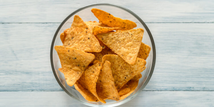 What do the black spots on the corn chips signify?